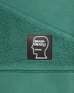 BRAIN DEAD / "LOGO HEAD" ASYMMETRICAL PANELED HOODIE